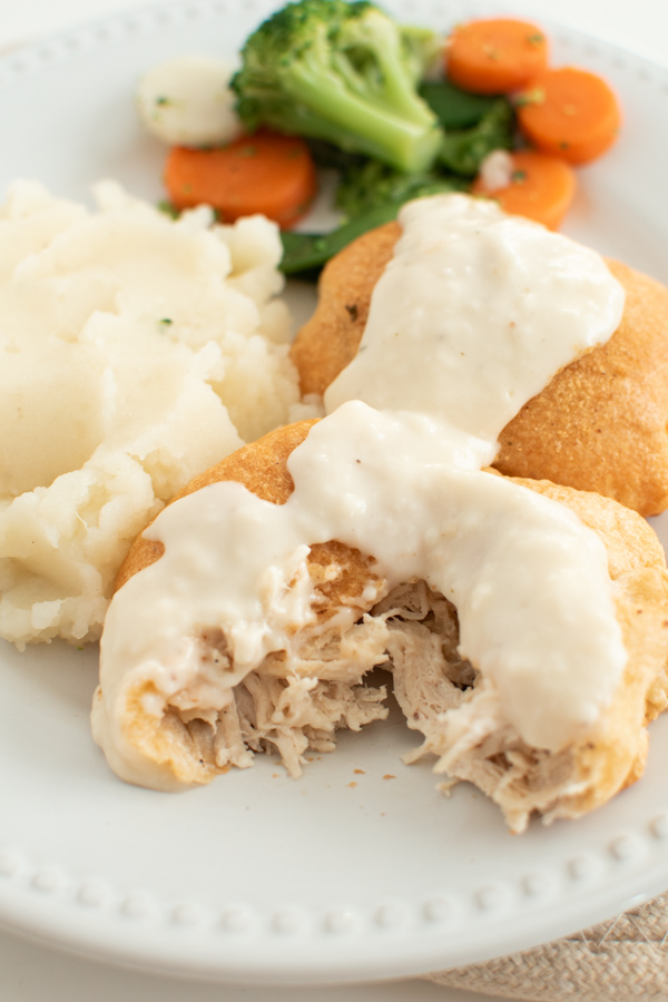 Chicken cream cheese crescent rolls on a dinner plate.