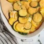 Pinterest graphic with text and photo of white baking dish full of squash casserole.