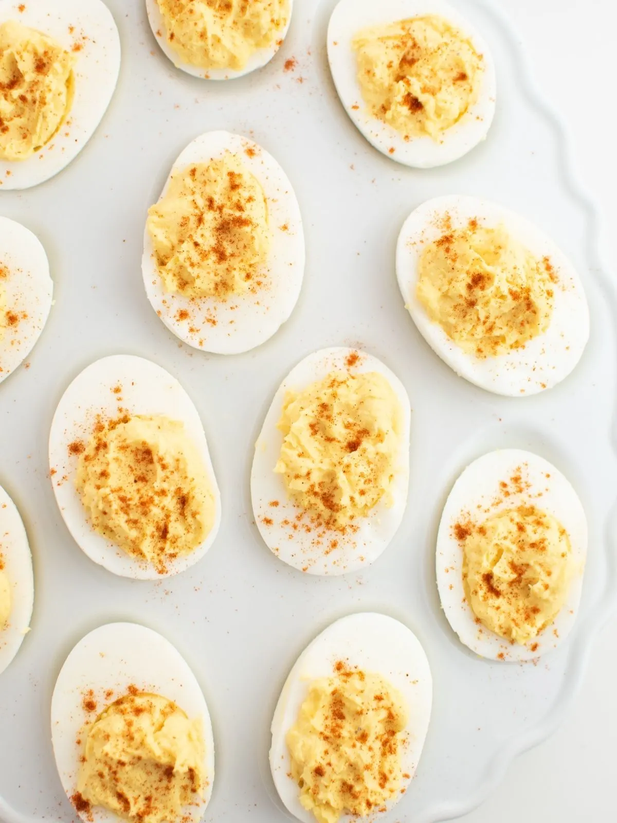 Deviled eggs on white platter.