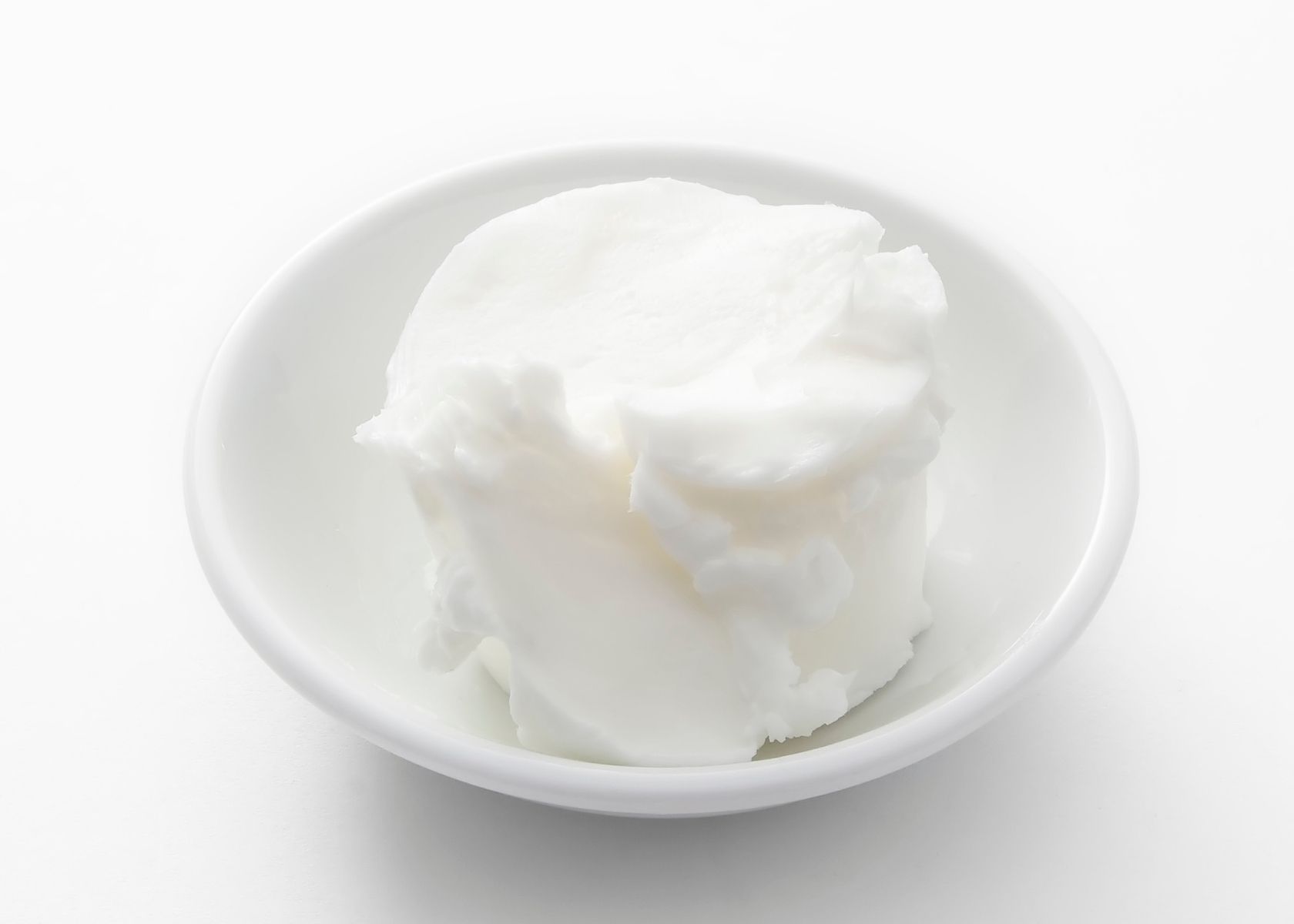 White vegetable shortening substitute for butter in white bowl on white surface.