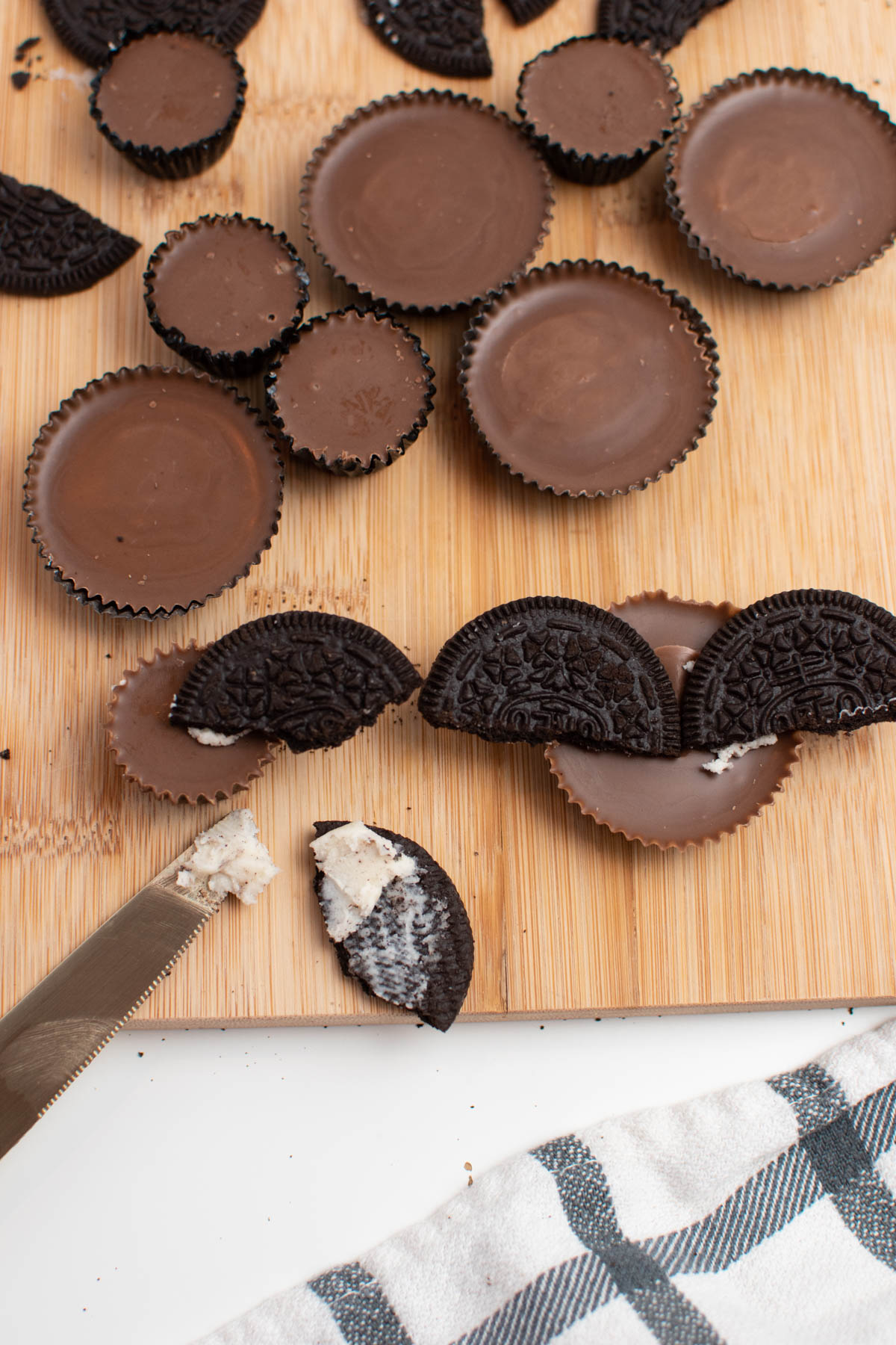 Frosted Oreo halves attached to Reese's cups with frosting.