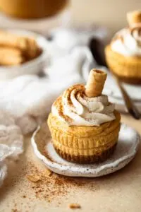 Close up of mini no bake pumpkin spice cheesecake on small plate.