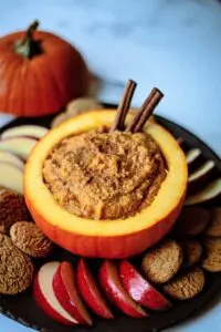 Pumpkin mascarpone served in a mini pumpkin with cinnamon sticks and fruit.