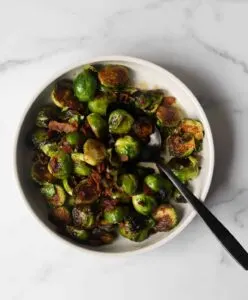 White bowl with maple mustard brussels sprouts.