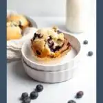 Pinterest graphic with text and photo of cake-like blueberry muffin on white ramekin.