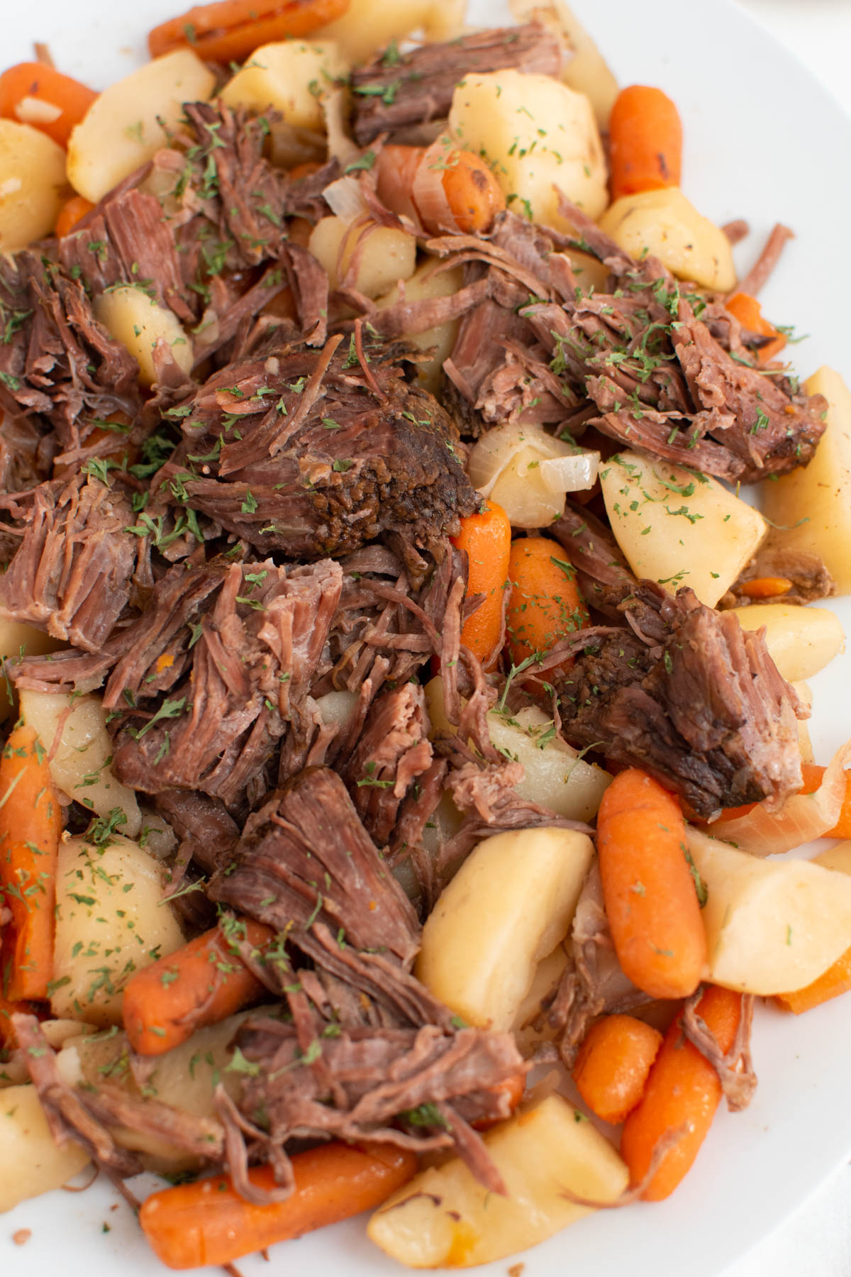 Close up of platter with Crock Pot roast, potatoes, carrots, and onion.
