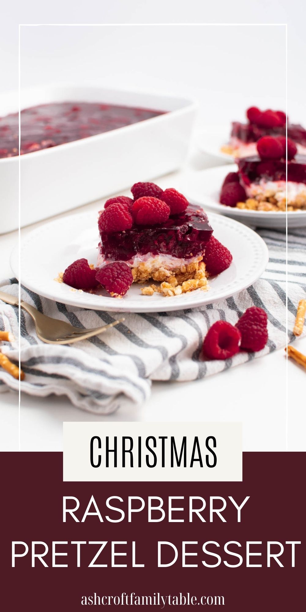 Pinterest graphic with text and photo of three pieces of raspberry pretzel dessert on white plates.