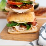 Pinterest graphic with text and two turket sandwiches stacked on each other.
