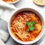 Pinterest graphic with text and photo of two bowls of lasagna soup.