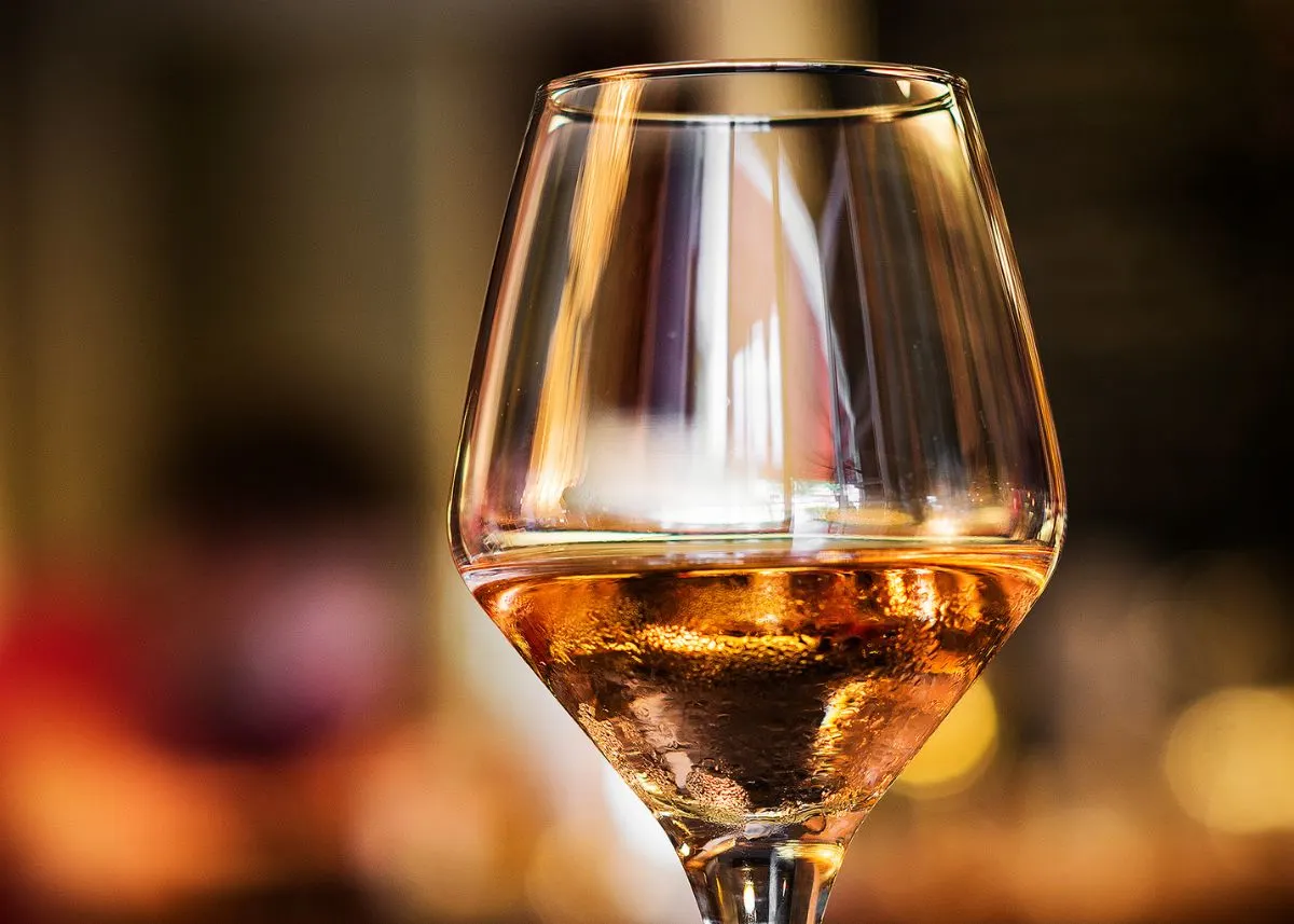 Close up of a partially filled glass of sherry wine with blurred background.