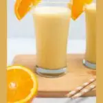 Pinterest graphic with text and photo of two glasses of Orange Julius made with powdered milk.