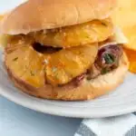 Pinterest graphic with text and photo of Hawaiian turkey burger on white plate.