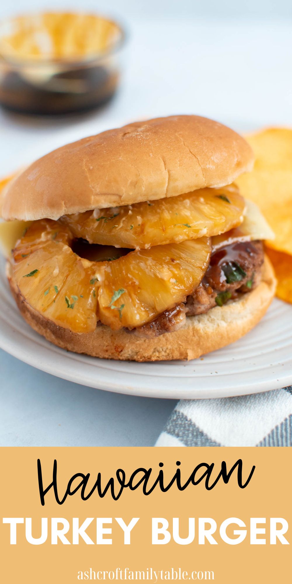 Pinterest graphic with text and photo of Hawaiian turkey burger on white plate.