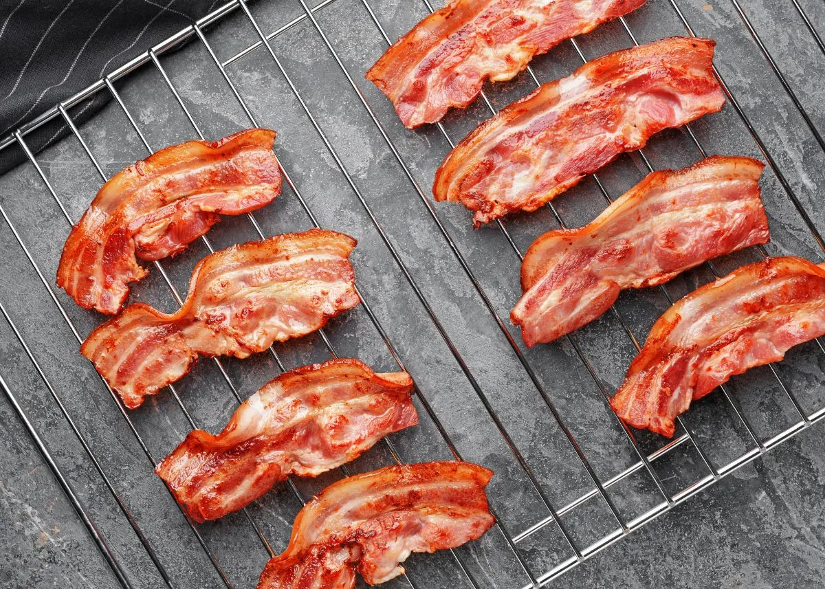 Several pieces of cooked bacon on a baking cooling rack.