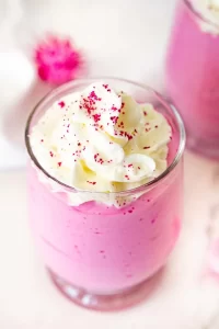 Pink Dragon fruit whipped cottage cheese in a clear glass.