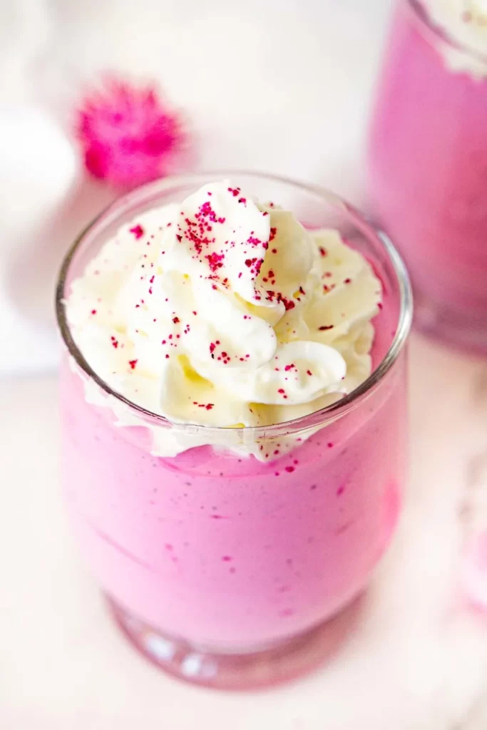 Pink Dragon fruit whipped cottage cheese in a clear glass.