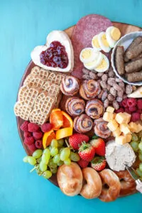 Breakfast charcuterie board with fruit, cheese, waffles, eggs, and more.