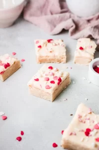 Sugar cookies bars with pink and red heart-shaped sprinkles.