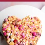Pinterest graphic with text overlay and photo of heart shaped popcorn cake.