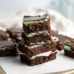 Pinterest graphic with text and a stack of mint chocolate brownies.