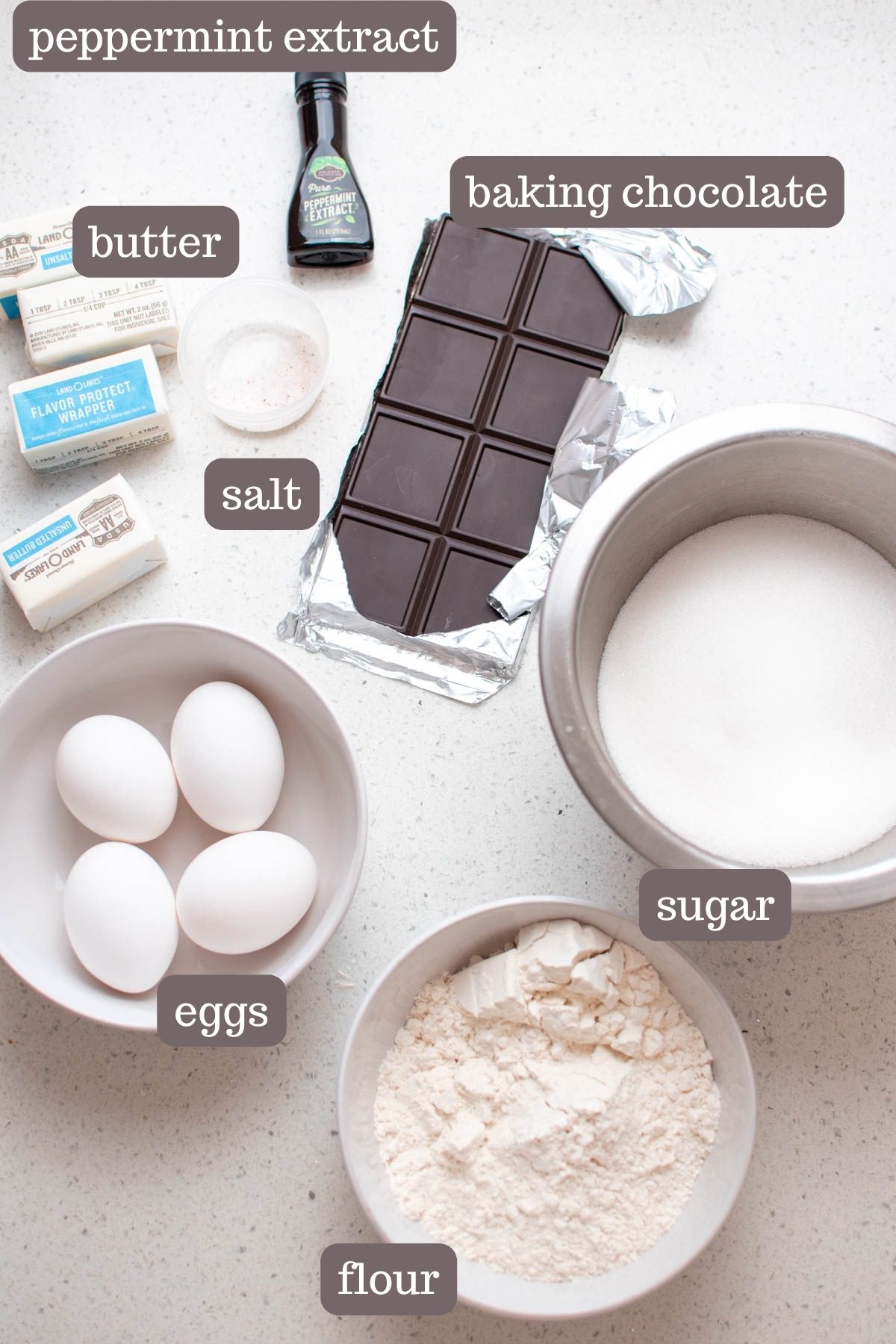 Labeled mint brownie ingredients on counter including eggs, sugar, and flour.