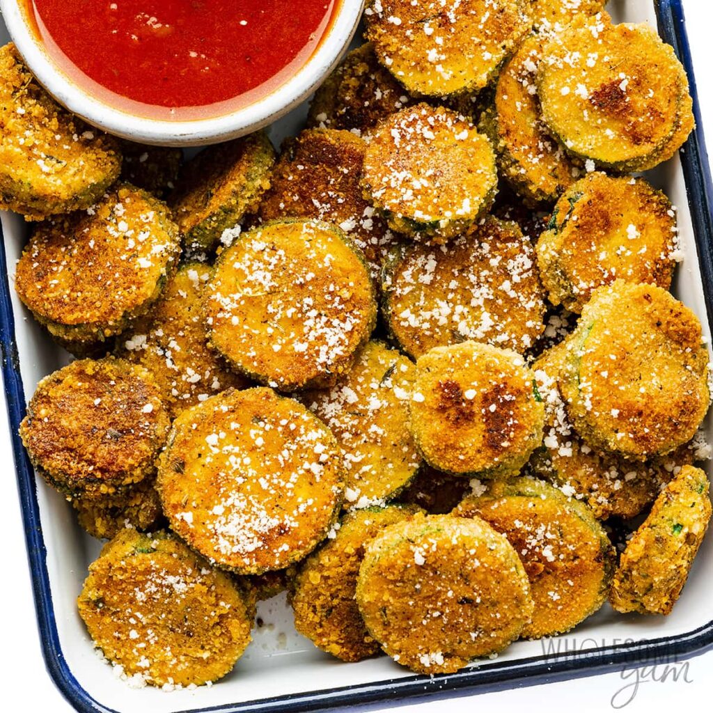 Breaded and fried squash with red dipping sauce.