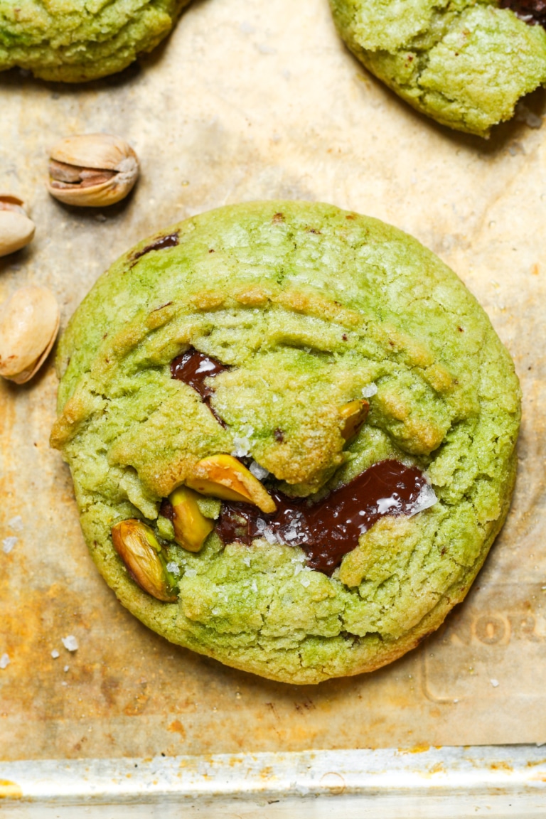 A green pistachio cookies with chocolate chunks.