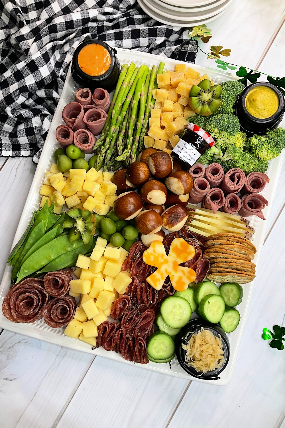 St. Patrick's Day charcuterie board with meat, cheese, veggies, and dip.