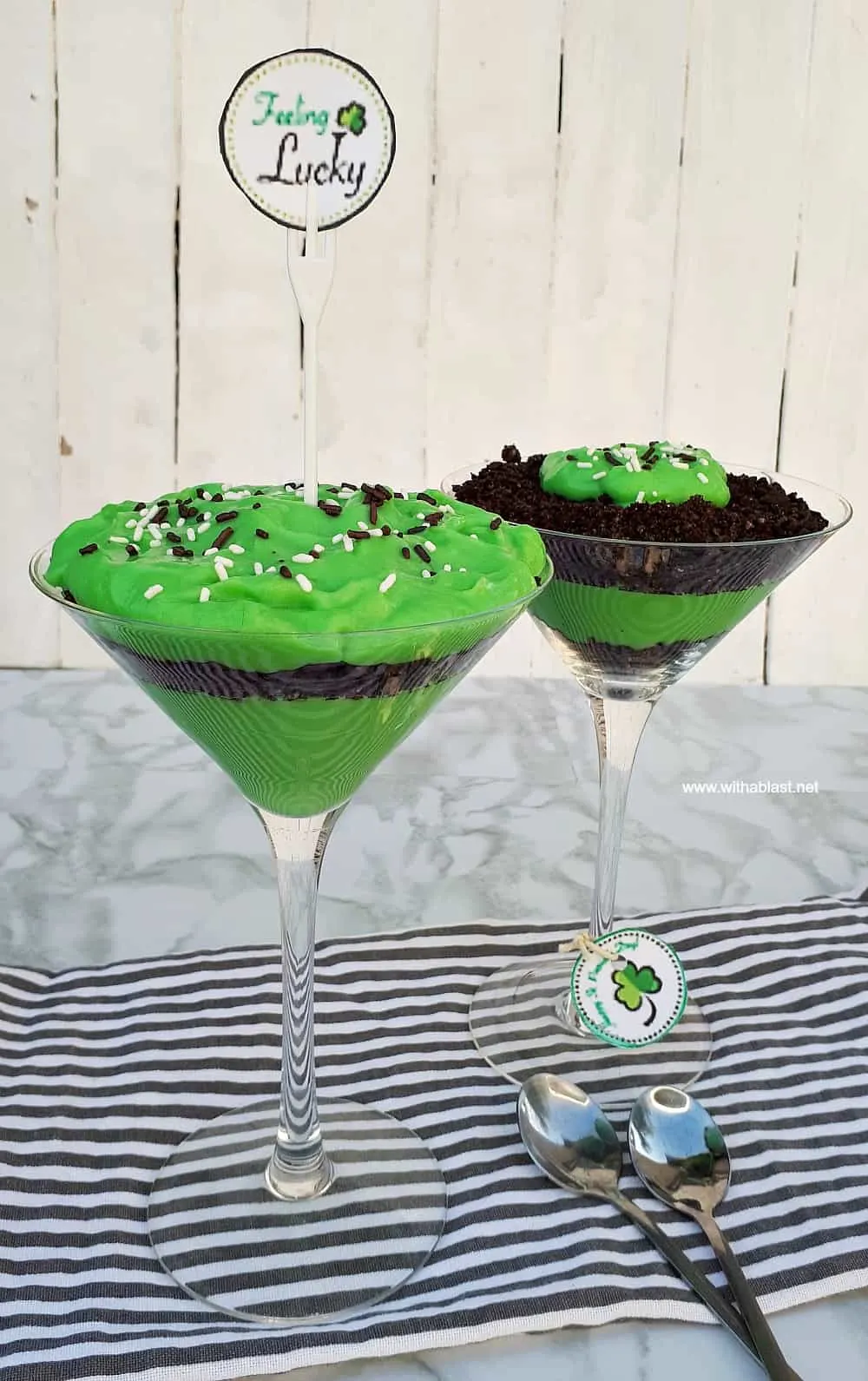 Green and brown layered dirt putting in champagne glasses with sprinkles on top.