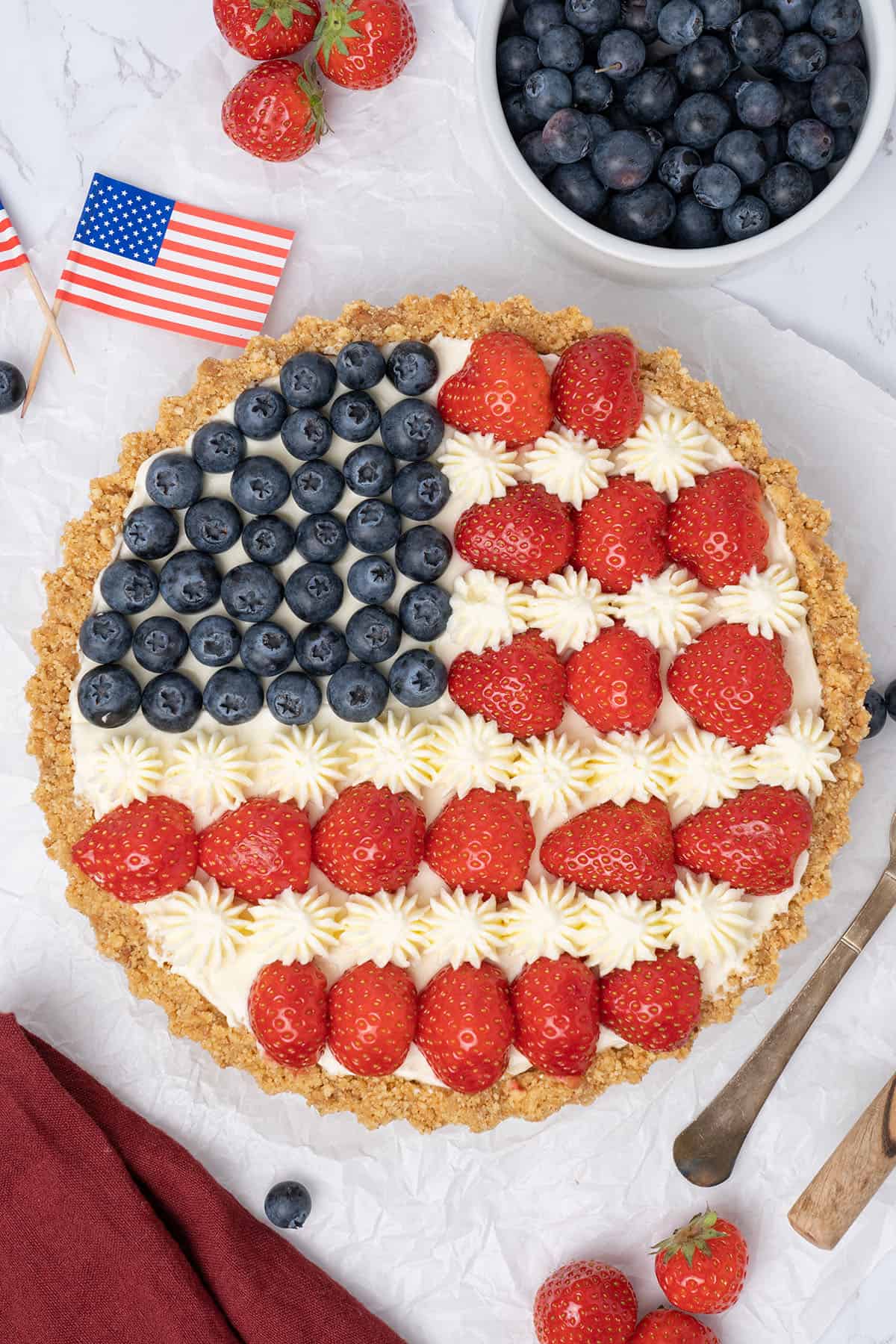 A pie with blueberries and strawberries in the pattern of an American flag.