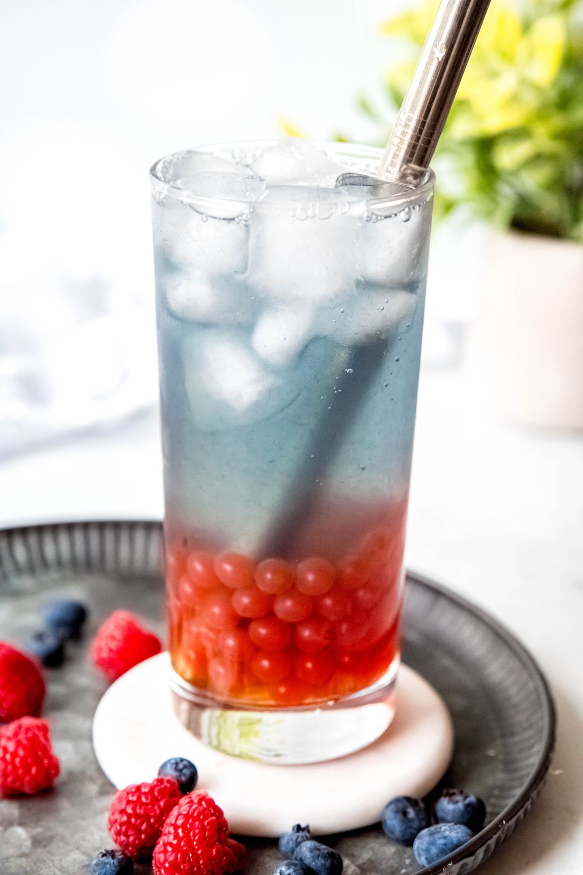 Red, white, and blue berry refresher drink on a serving platter.