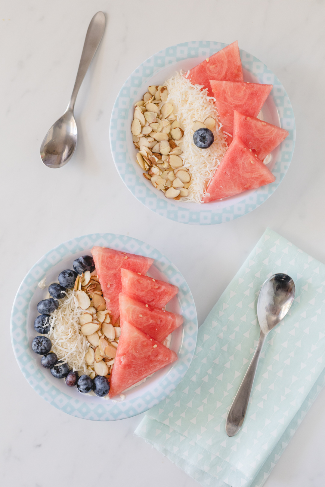 Two watermelon power bowls with yogurt, oats, and blueberries.