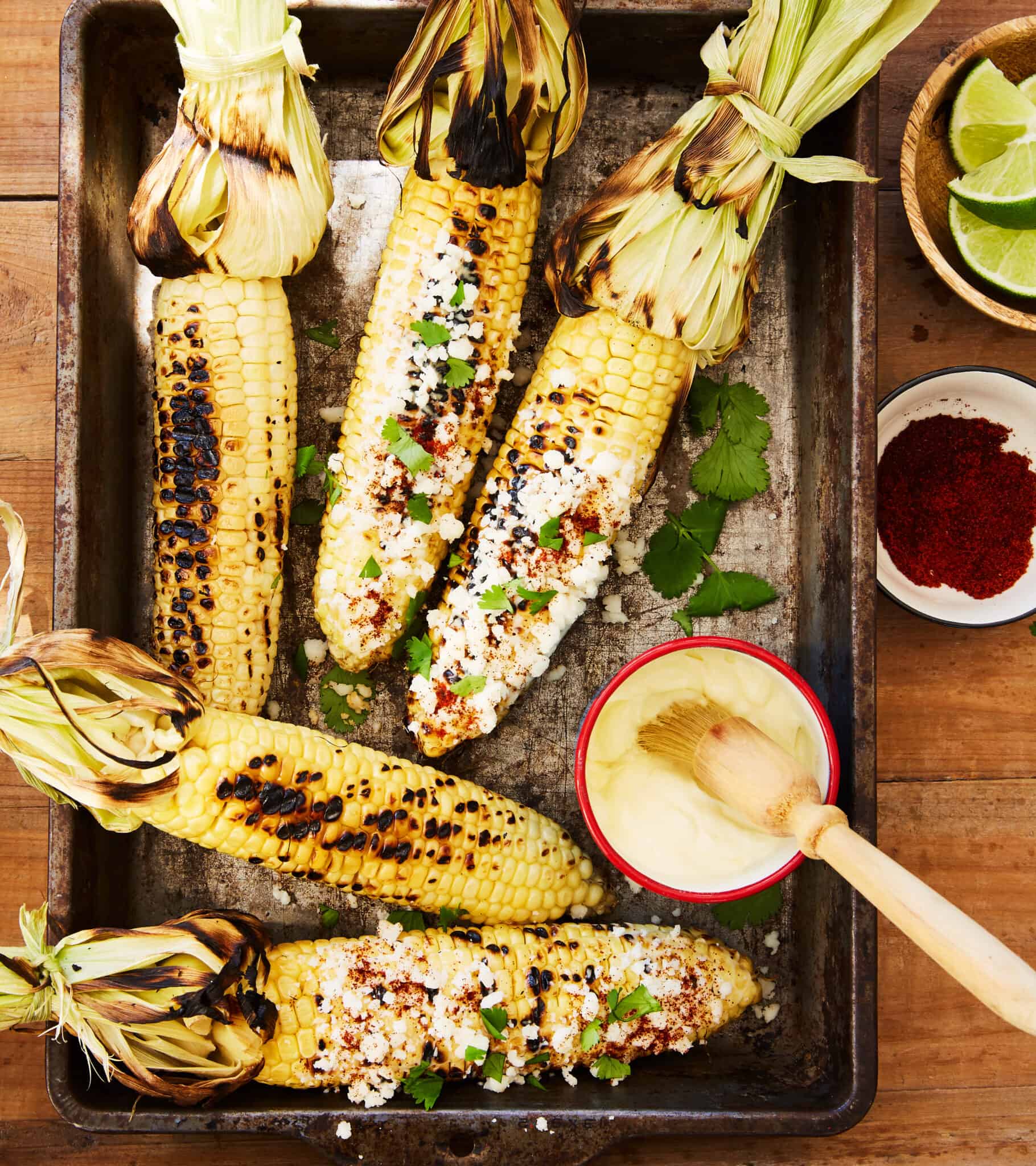 Smoked Mexican street corn on the cob on a sheet pan.