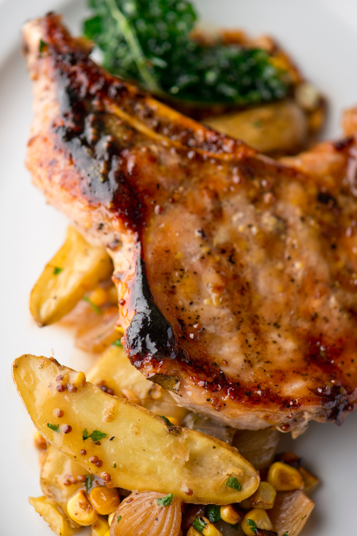 Smoked, bone-in pork chop with vegetables and honey mustard glaze.