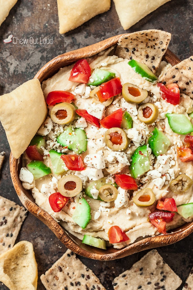 7 layer Mediterranean dip with olives, cucumbers, tomatoes, and feta.