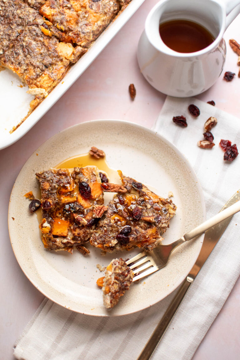 Two pieces of maple pecan sweet potato bake and gold fork on plate.