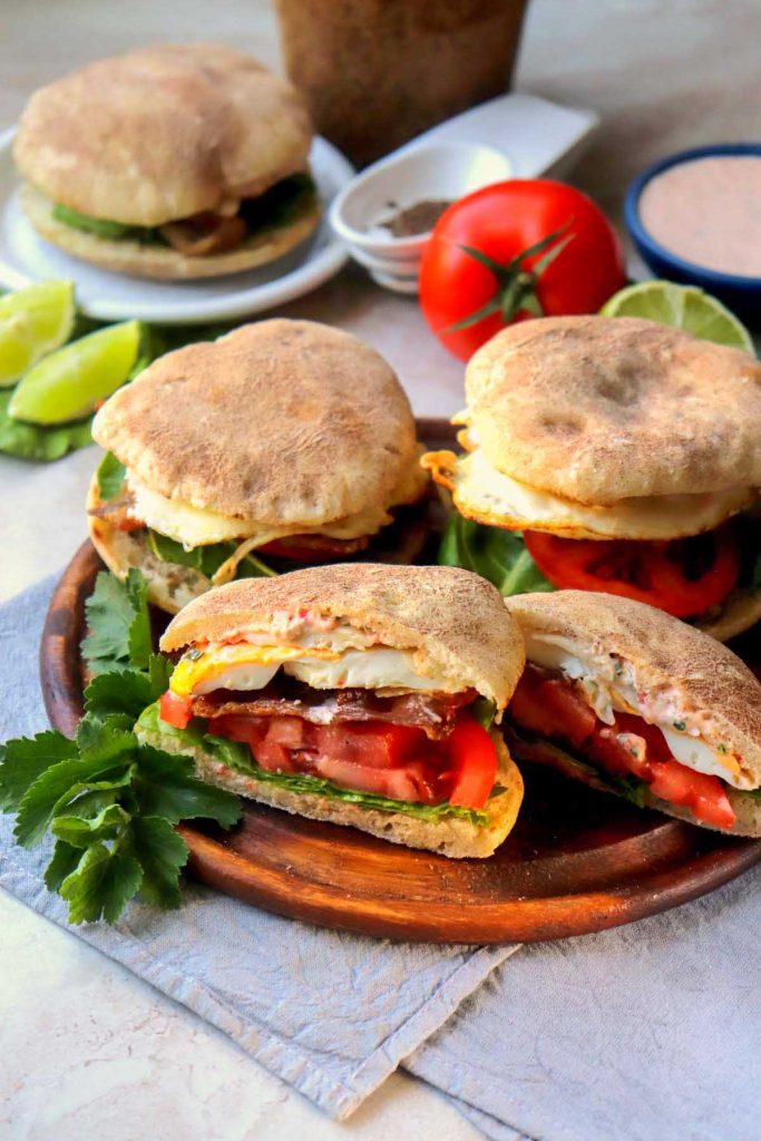 Baja sauce breakfast sandwiches on a red plate.