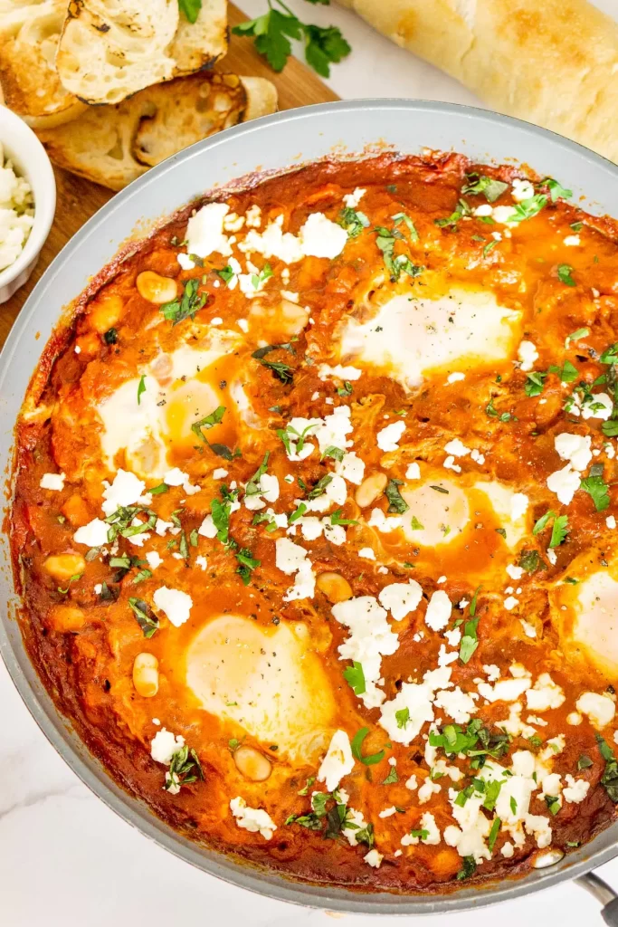 Shakshuka with feta cheese in a large skillet.