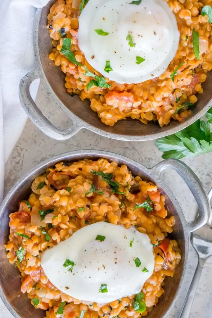 Breakfast lentils with poached eggs on top.
