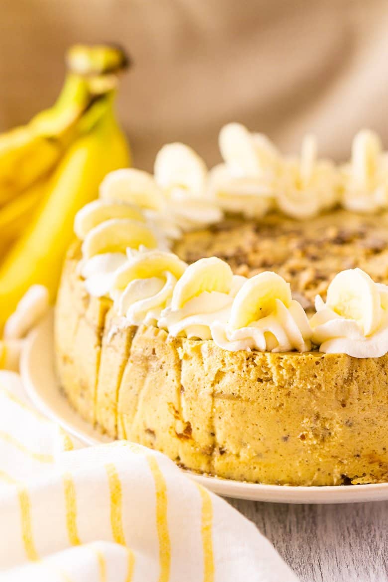 Bananas foster cheesecake with toffee and sliced bananas on top.