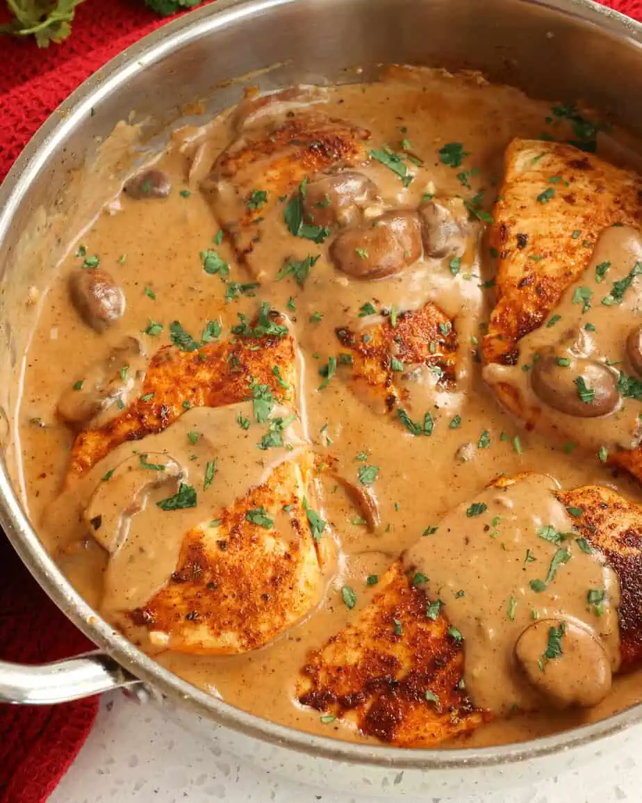 Creamy Cajun chicken in a metal skillet.
