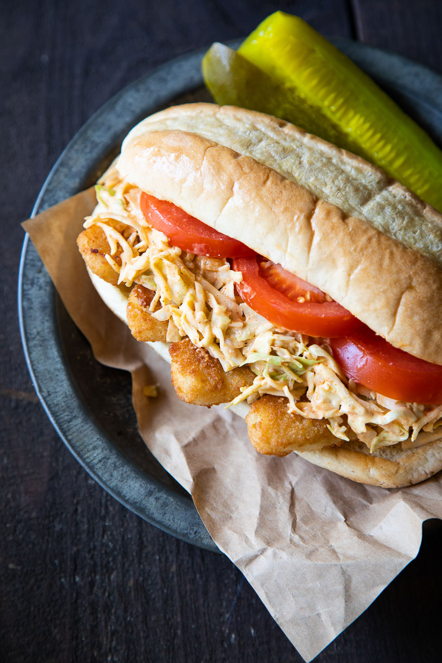 Fish Po' boys with Cajun slaw and pickles on the side.