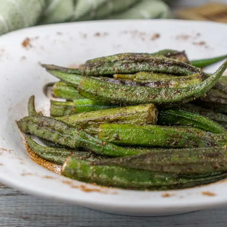 Cajun okra in a large shallow white bowl.
