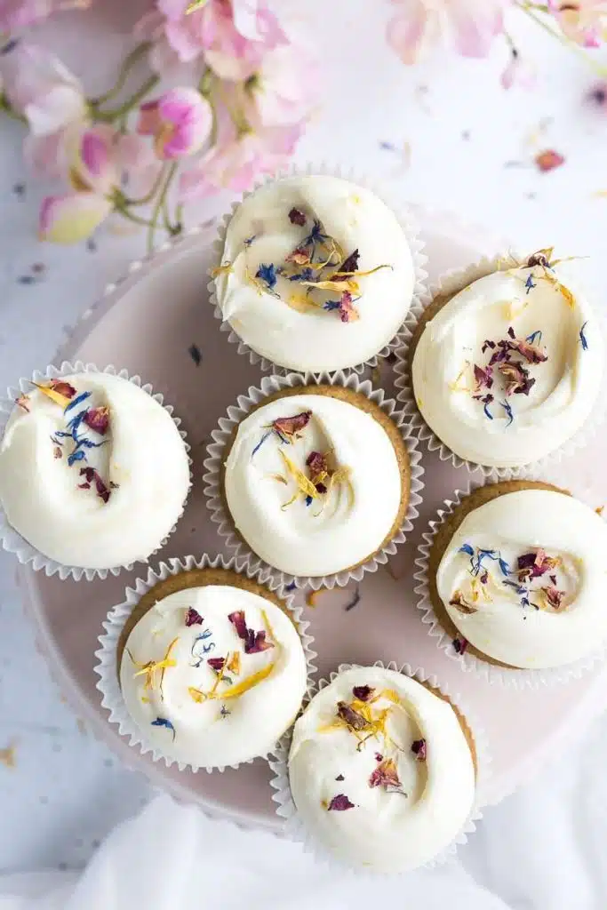 Honey lemon cupcakes with dried edible flowers on top.