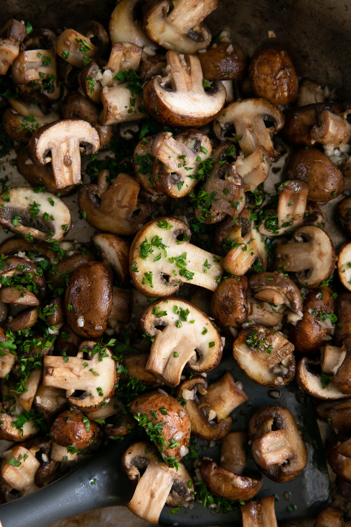 Small sauteed mushrooms with green sauce.