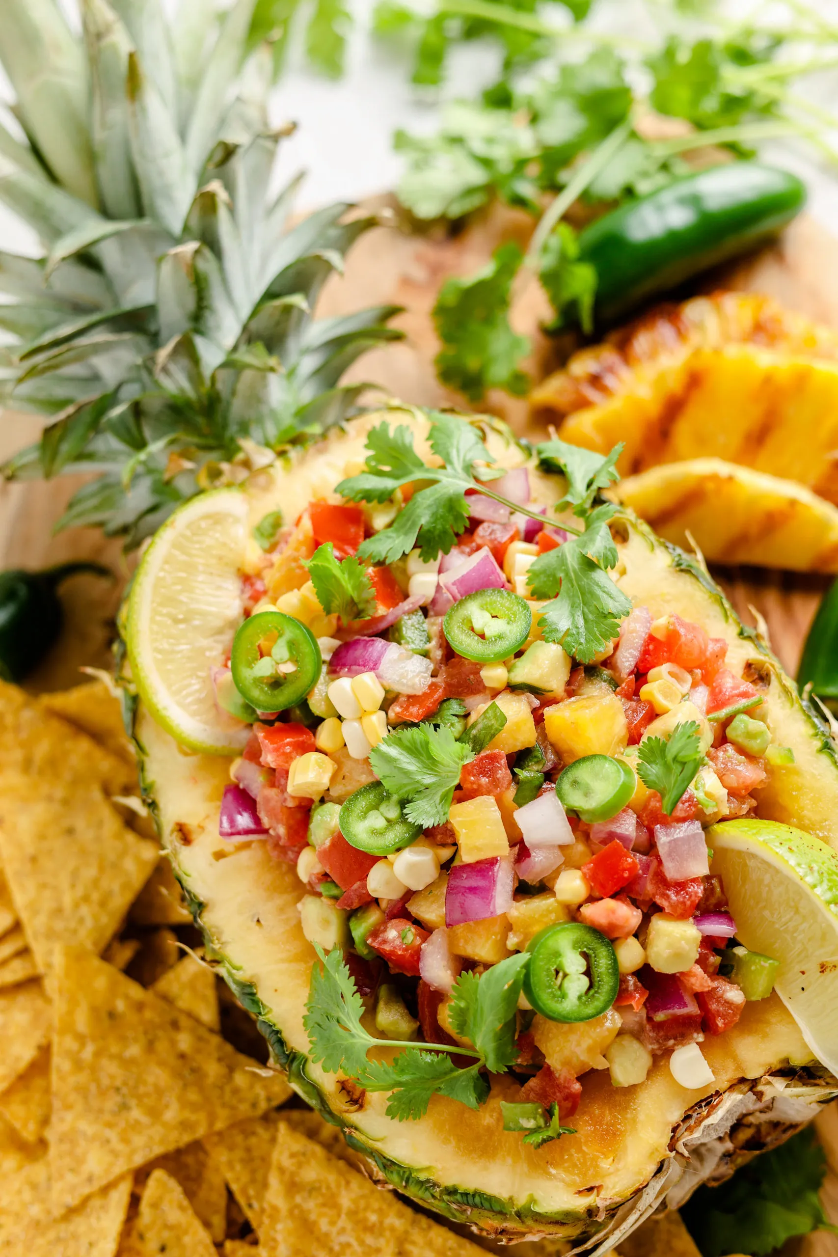 Grilled pineapple salsa in a hollowed out pineapple with jalapenos and lime.