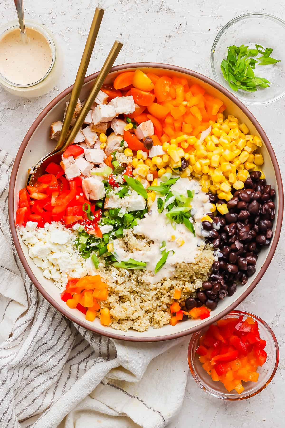 Southwest quinoa chicken salad meal prep bowl with beans and corn.