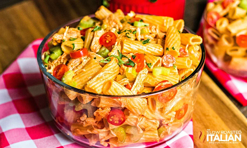 Buffalo chicken pasta salad in a clear glass bowl/
