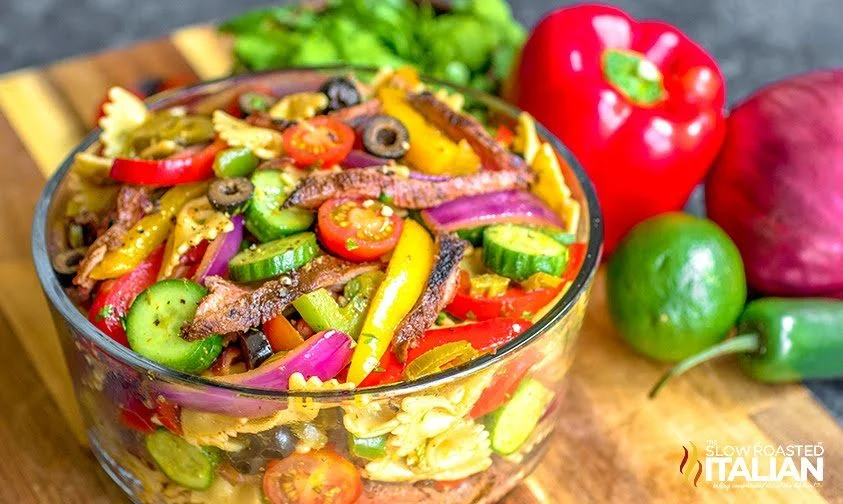 Mexican pasta salad with bell peppers, red onion, and flank steak.