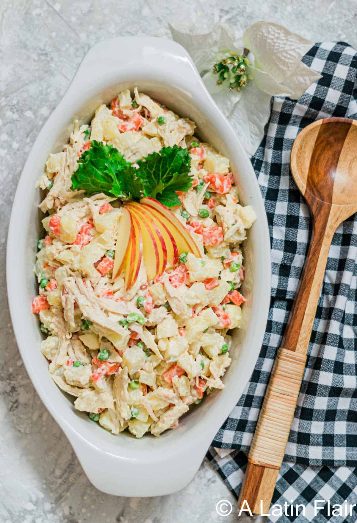 Chicken salad with potatoes and creamy dressing in a large oval casserole dish.